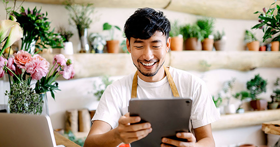 man on ipad in flower shop