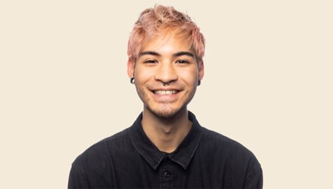Man with pink hair smiling