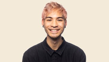 Man with pink hair smiling