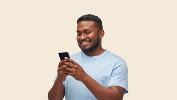 man in blue shirt holding phone