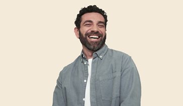 man laughing in grey shirt