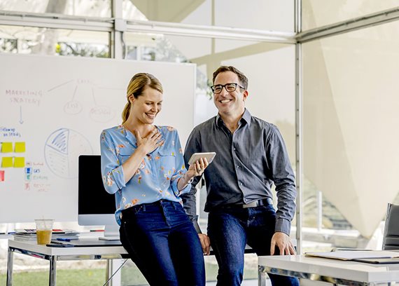 People chatting in front of whiteboard